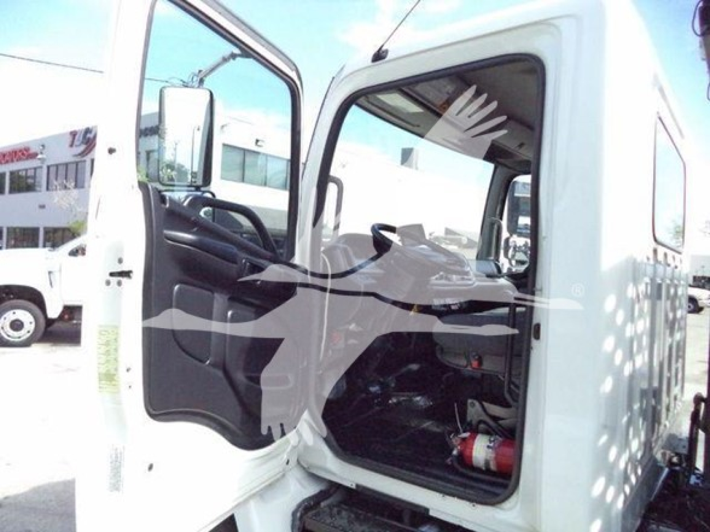 Truck cab interior of a 2017 Hino 258LP with door open, showing steering wheel, driver's seat, dashboard, and passenger seat area.