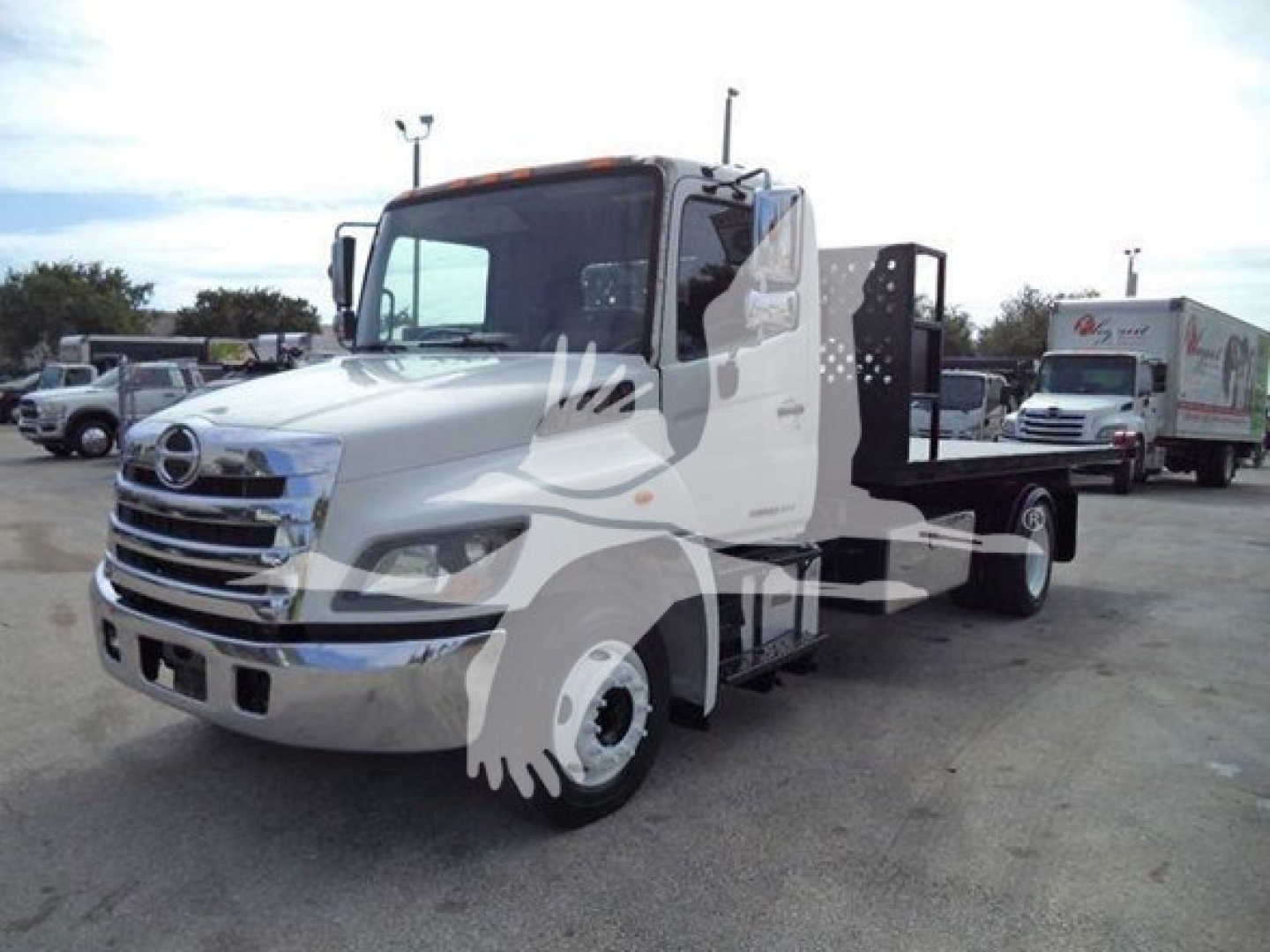 Truck chassis with hooklift body on a 2017 Hino 258LP showing side profile, chrome grille, cab, and hooklift frame.