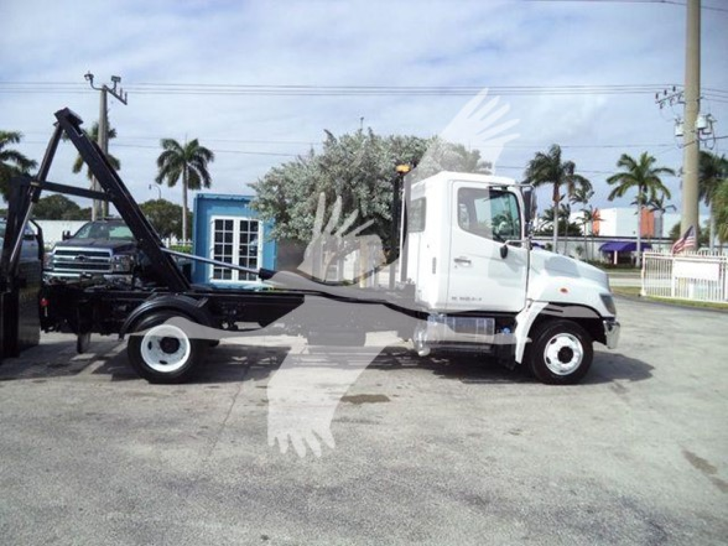 Truck showing hooklift system on a 2017 Hino 258LP with stock number T52712 and VIN 5PVNJ8JNXH4S52712.