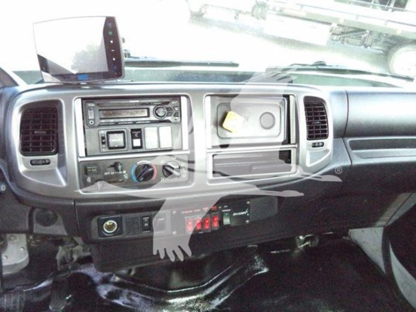 Dashboard view of a 2017 Hino 258LP cab showing steering wheel, center console with radio, climate controls, and storage compartments.