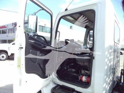 Truck cab interior of a 2017 Hino 258LP with door open, showing steering wheel, driver's seat, dashboard, and passenger seat area.