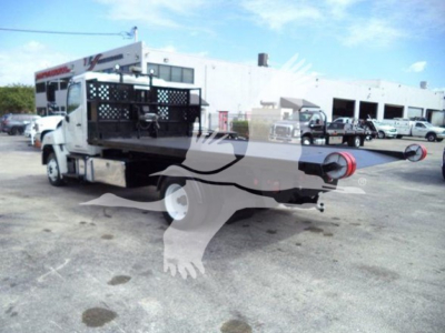 Truck bed of a 2017 Hino 258LP hooklift vehicle showing rear apparatus and port fittings.