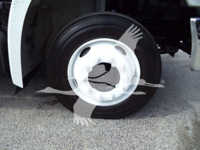 Wheel and tire close-up on a 2017 Hino 258LP hooklift truck showing white steel wheel and black tire.