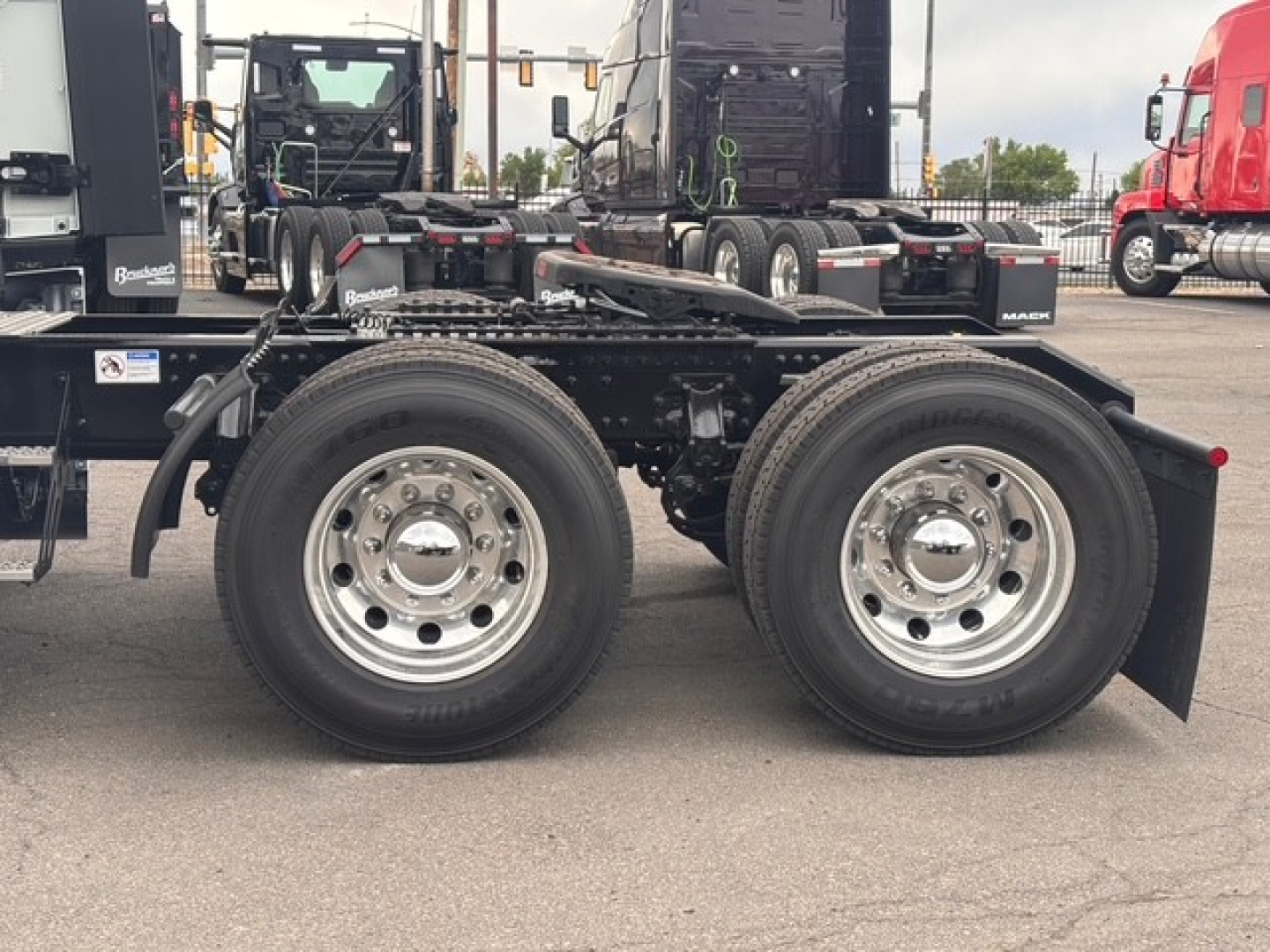Mack PR64T76H drivetrain rear chassis showing dual rear axles and chrome wheels.