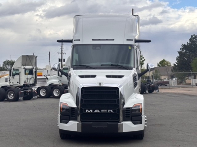 Front view of a white 2026 Mack PR64T76H conventional sleeper truck with black grille and large hood, showing Mack emblem and headlights.