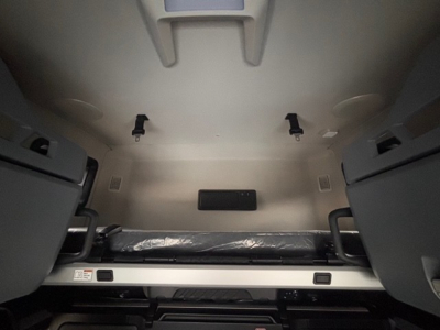 Truck cab interior showing bunk area and storage compartments in a Mack PR64T76H sleeper cab.