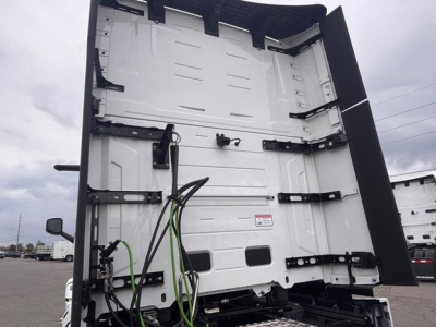 Mack PR64T76H truck cab interior showing rear wall and side access panels with wiring harnesses.