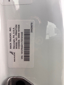 Label on truck showing MACK TRUCKS INC model CHASSIS PR101035 VIN 1M1PR4GY1TM101035 barcode text