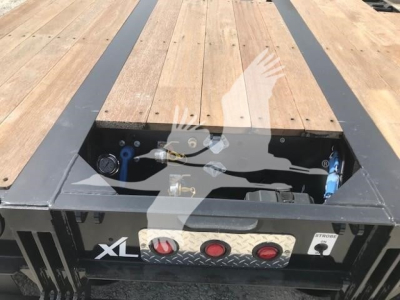 Trailer deck area showing toolbox and controls on XL Specialized XL80Mfga lowboy trailer with wooden deck.