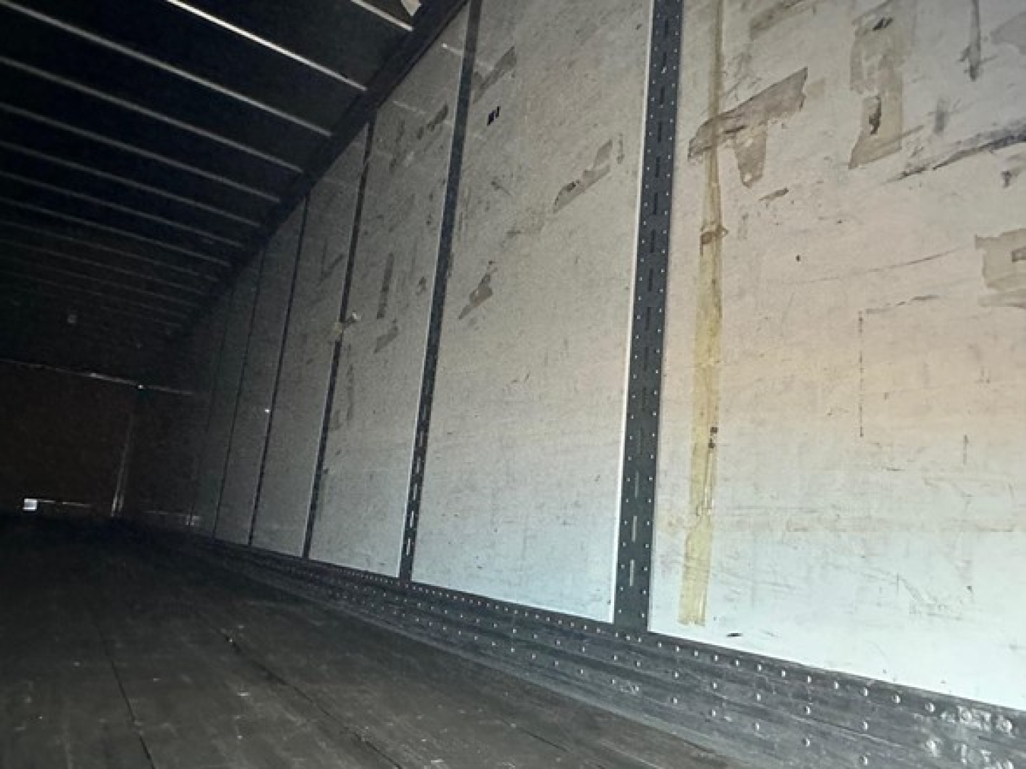 Interior of Hyundai air ride dry van trailer with roll-up door tracks and ribbed aluminum walls seen from inside the cargo area.