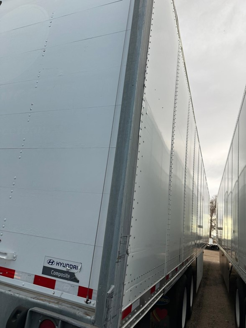 Hyundai air ride dry van trailer showing side panel with Hyundai Composite logo and rear lights near lower corner.
