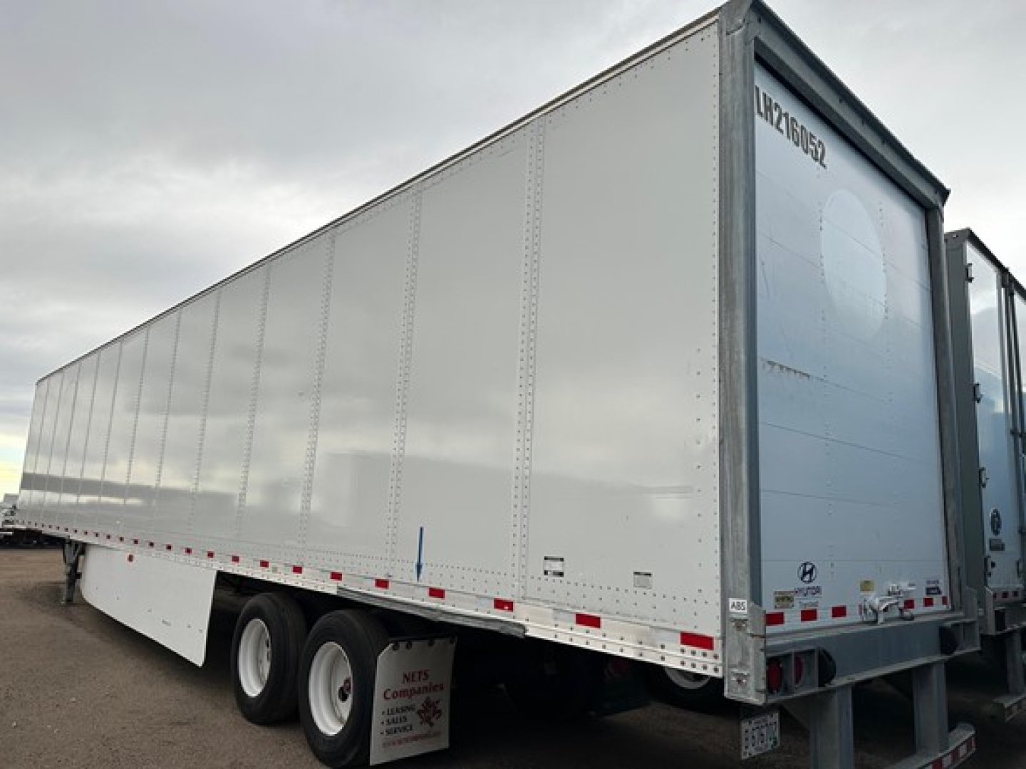 Trailer side view of a 2017 Hyundai air ride dry van showing white exterior and rear doors.