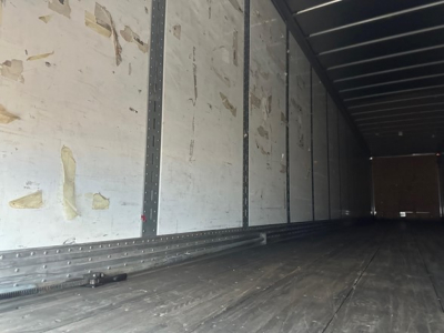 Hyundai air ride dry van trailer interior showing long empty cargo area with metal wall posts and ribbed floor.