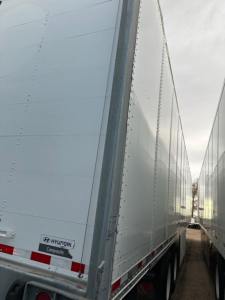 Hyundai air ride dry van trailer showing rear corner with Hyundai Composite logo and riveted side panel