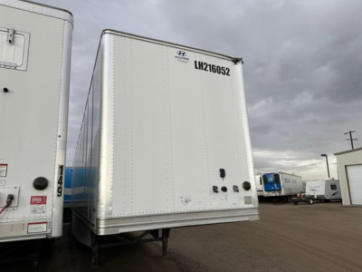 Trailer rear view showing LH216052 and riveted aluminum doors on a 2017 Hyundai air ride dry van with roll-up doors.