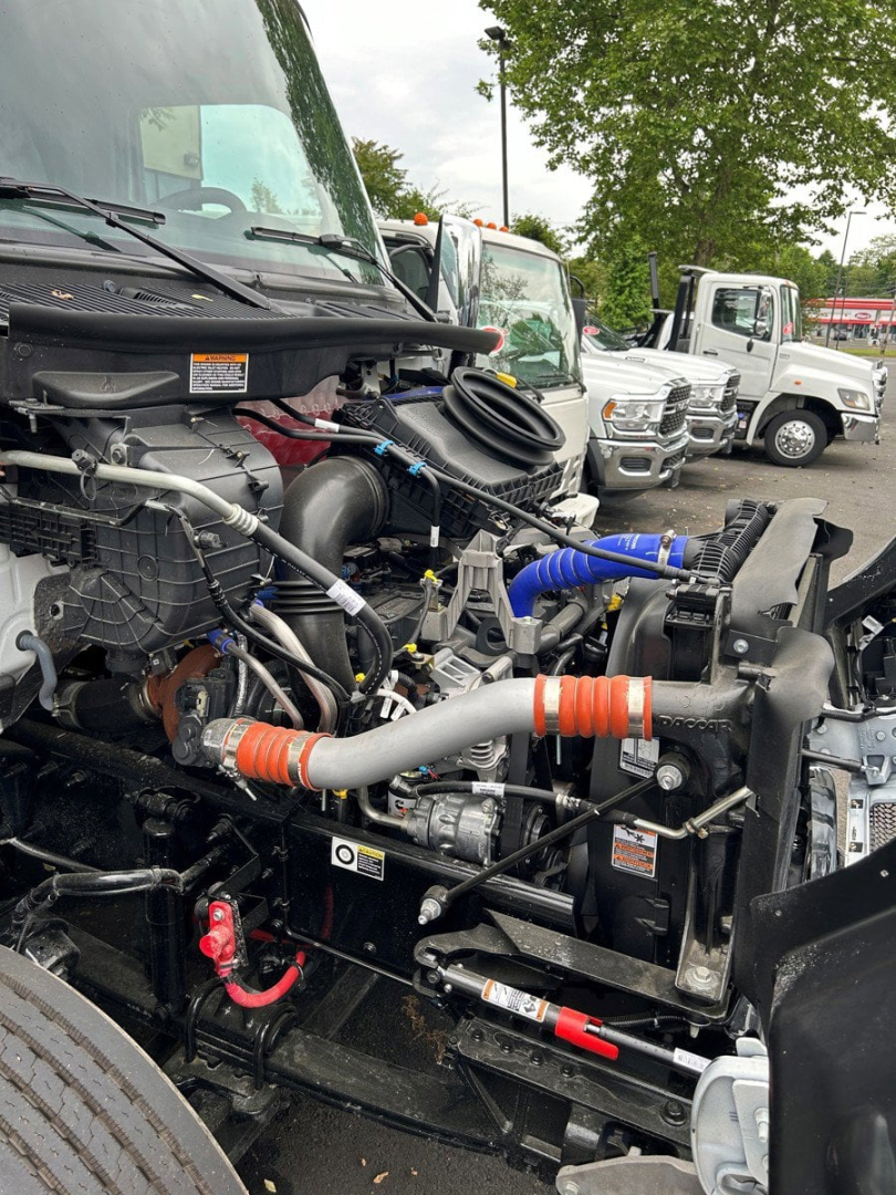 Kenworth T280 engine bay showing intake hoses and front radiator area.