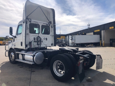 Truck cab rear view showing Freightliner Cascadia 116 with chassis and fuel tanks visible.