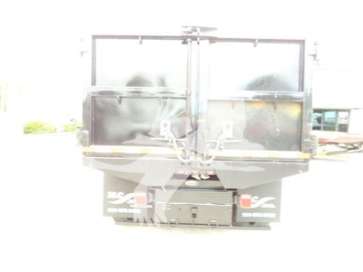 Rear view of a 2019 International 4300 dump truck with dual tailgate doors and rear bumper. Visible text includes 'ISUZU?' no, the license plates are not legible; the image shows a cargo bed with tailgate latches.