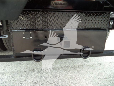 Storage toolbox and rear bumper on a 2019 International 4300 dump truck viewed from rear showing diamond tread toolbox and D-rings.