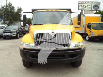 Front view of a yellow 2019 International 4300 dump truck with large chrome grille and vertical headlights.