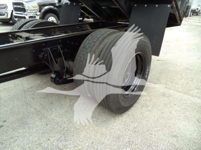 Truck rear axle and dual rear wheels of a 2019 International 4300 dump truck showing tire and suspension components.