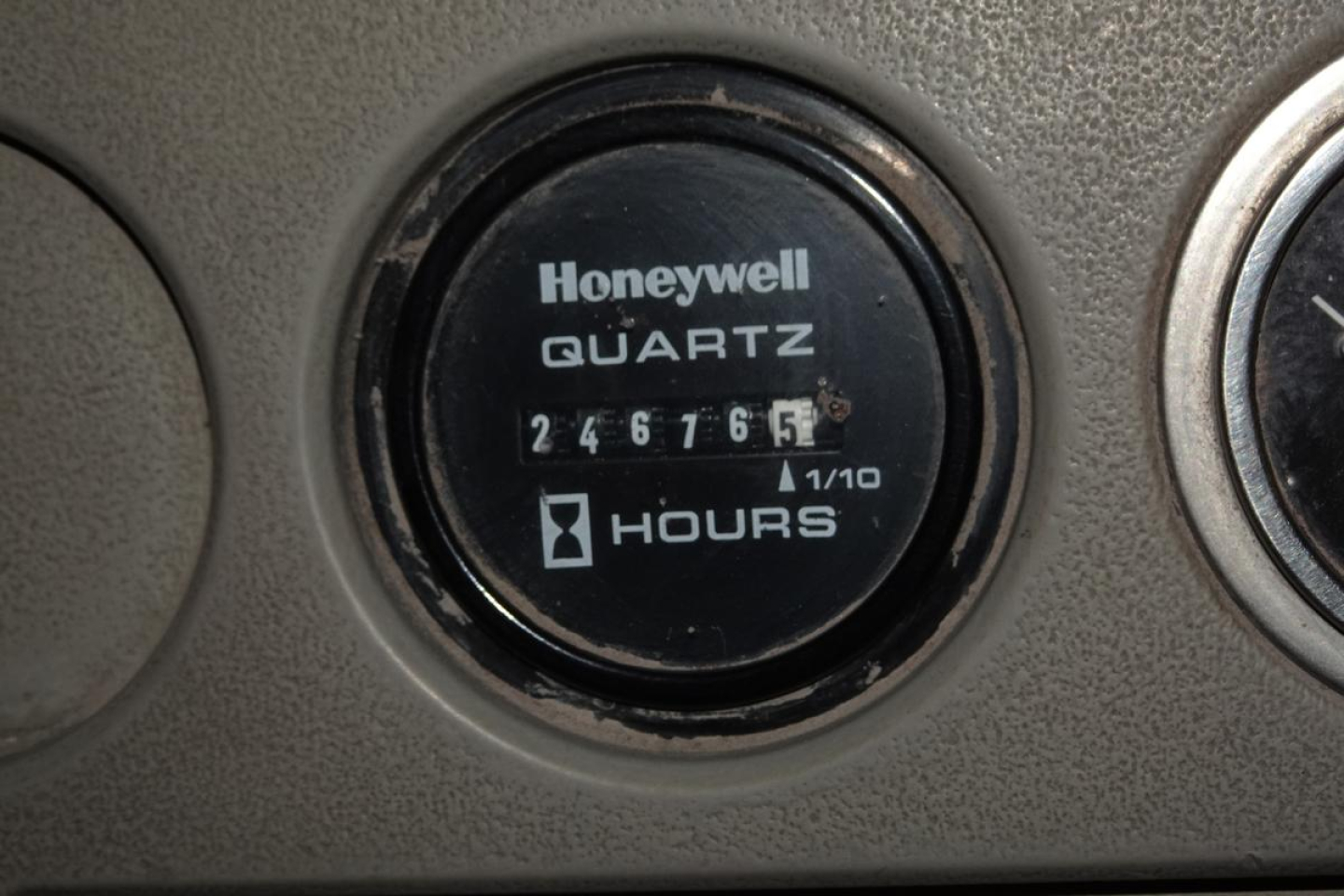 Dashboard gauge showing Honeywell Quartz hour meter reading 246765 hours on TJ5000 yard truck