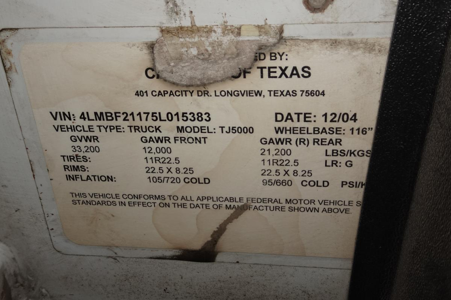 Label on vehicle showing VIN 4LMBF21175L015383, GAWR front 12,000, GAWR rear 21,000, gross vehicle weight 33,200, tires 11R22.5, rims 22.5x8.25, cold inflation 105/260 PSI, date 12/04, capacity TJ5000, capacity: 401.