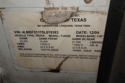 Label on vehicle showing VIN 4LMBF21175L015383, GAWR front 12,000, GAWR rear 21,000, gross vehicle weight 33,200, tires 11R22.5, rims 22.5x8.25, cold inflation 105/260 PSI, date 12/04, capacity TJ5000, capacity: 401.