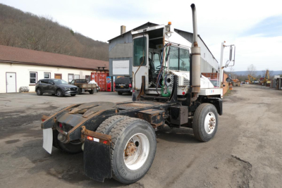 Capacity TJ5000 yard truck chassis with cab and exposed drivetrain showing rear dual tires and exhaust stack.