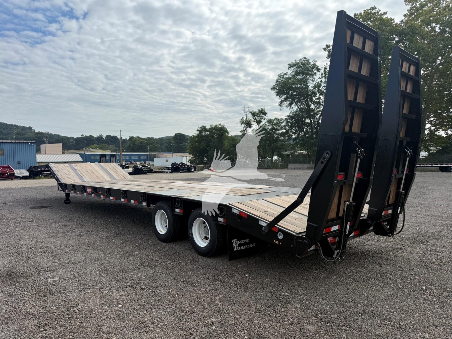 Trailer showing a Dorsey Lb35-33Cs drop deck trailer with loading ramps raised, dual rear axles, and wooden deck. VIN 7KYLB352XVED49580 visible on stock plate.