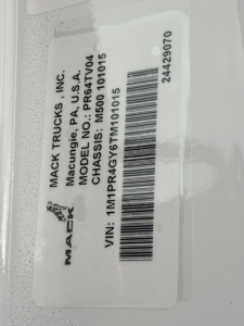 Mack Trucks tag with VIN 1M1PR4GY6TM101015, model PR64T04, CHASSIS NO: PR64T04, MAC K TRUCKS INC label, barcode, stock number 71642, category conventional sleeper