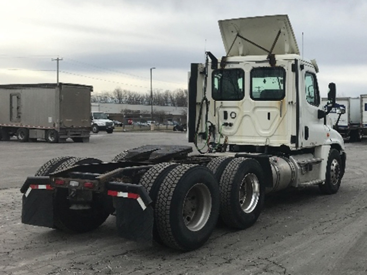 Truck chassis rear view showing Freightliner Cascadia125 cab with dual rear axles and fifth wheel area.
