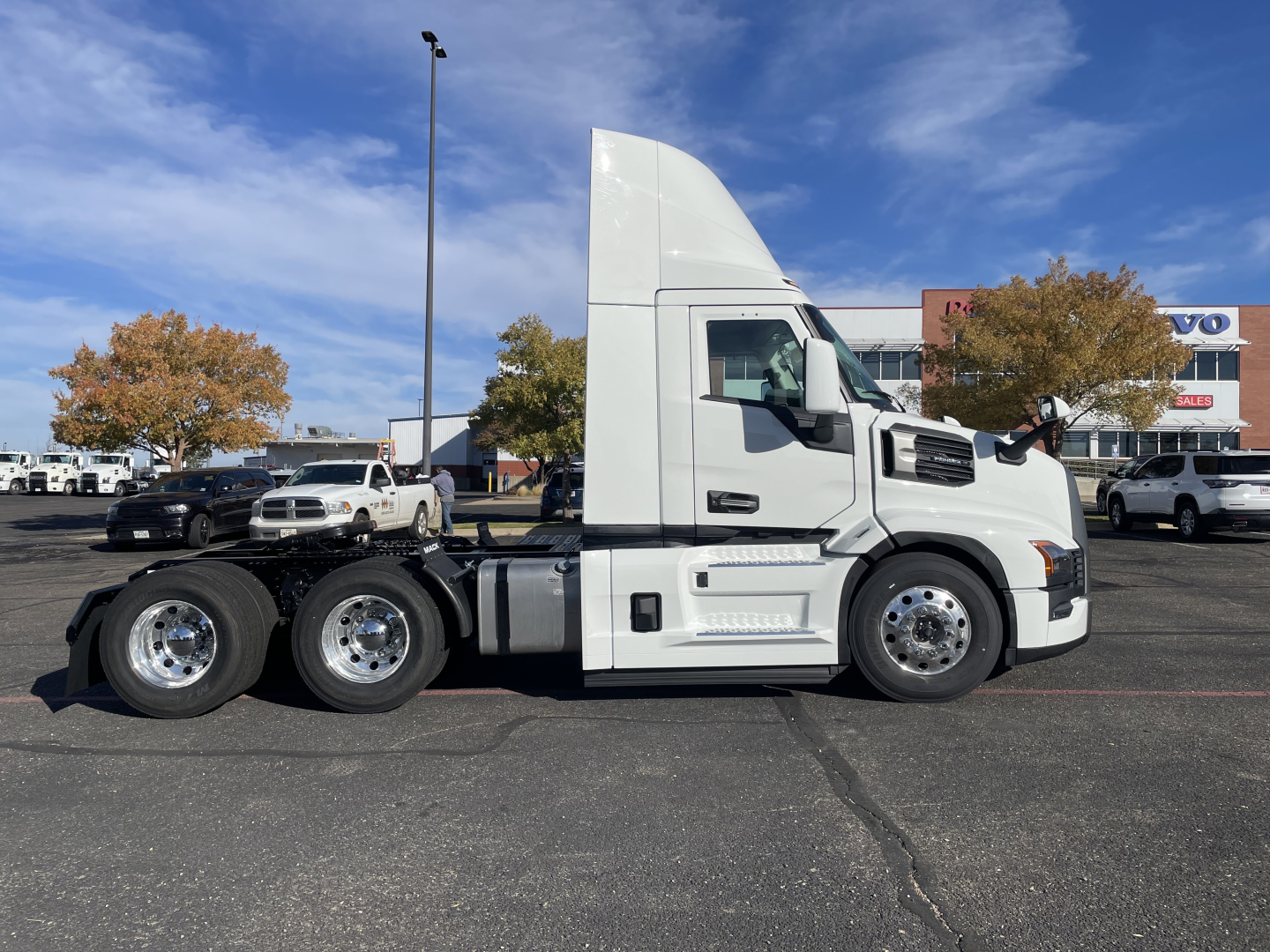 Mack PR64T tractor truck side view showing concrete sleeper cab and dual rear axles with chrome wheels.