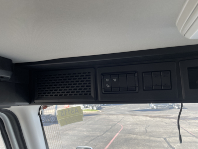 Truck cab interior dash area with control switches and vent visible in Mack PR64T listing.