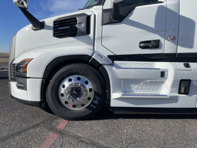 Mack PR64T truck front wheel and cab profile showing side step and badge.
