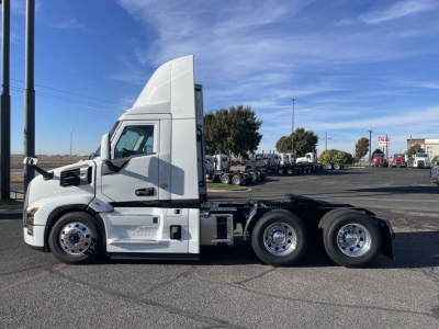 Mack PR64T tractor unit side view showing cab and dual rear axles with chrome wheels.