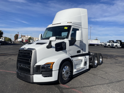 Mack PR64T truck in a parking lot, front-left view with high sleeper cab and dual rear axles. VIN/stock not visible on image; no readable labels.
