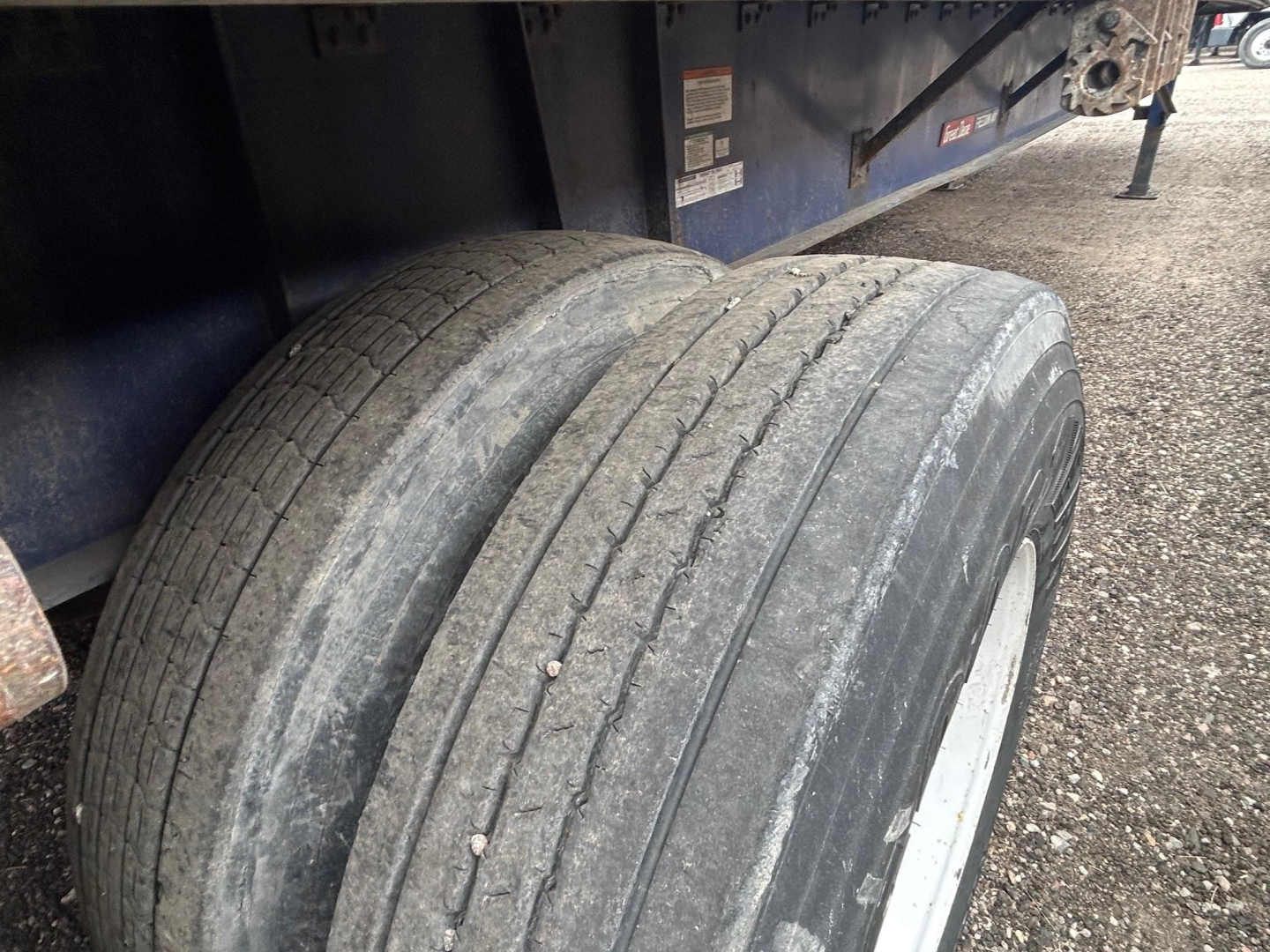 Dual tire axle of a 2016 Great Dane steel spread air flatbed trailer showing tread wear and wheel rims.