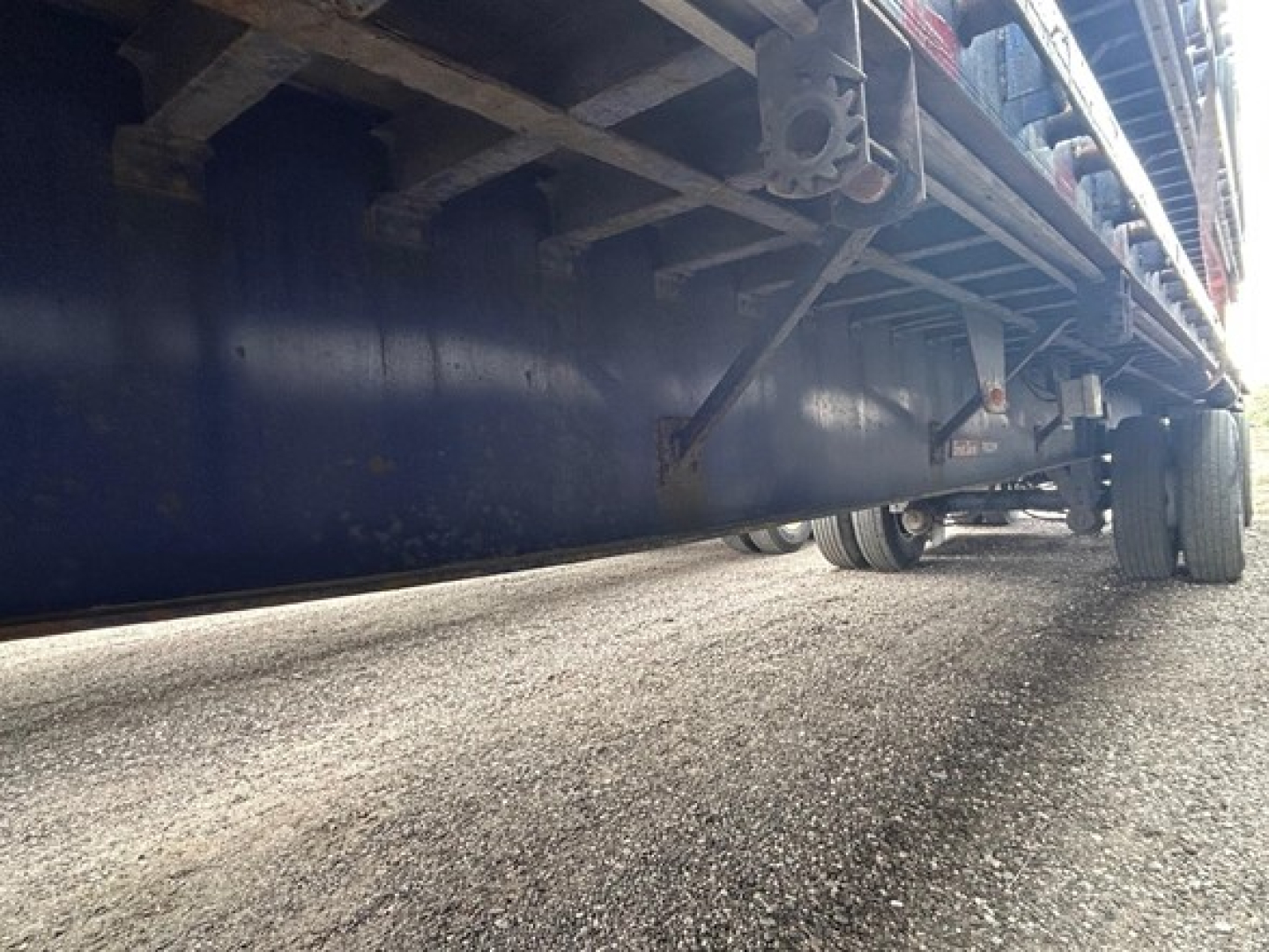 Great Dane steel spread air flatbed trailer side view showing underside and wheels