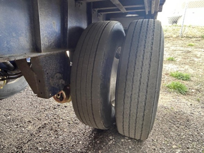 Dual rear wheels on a Great Dane steel spread air flatbed trailer showing tires and undercarriage components.