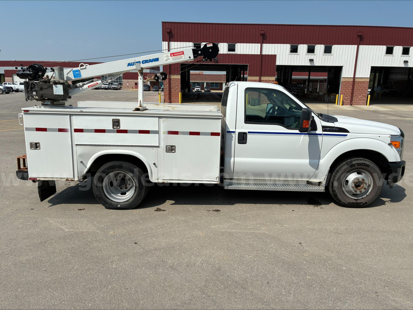Ford F-350 utility/service truck in service condition showing utility bed and crane