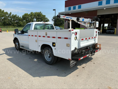 Service/utility truck bed with crane in white, rear view showing utility body and equipment area