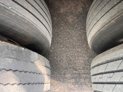 Rear view of a Great Dane air ride reefer trailer showing dual axles and rubber tires with road grime on the surface.