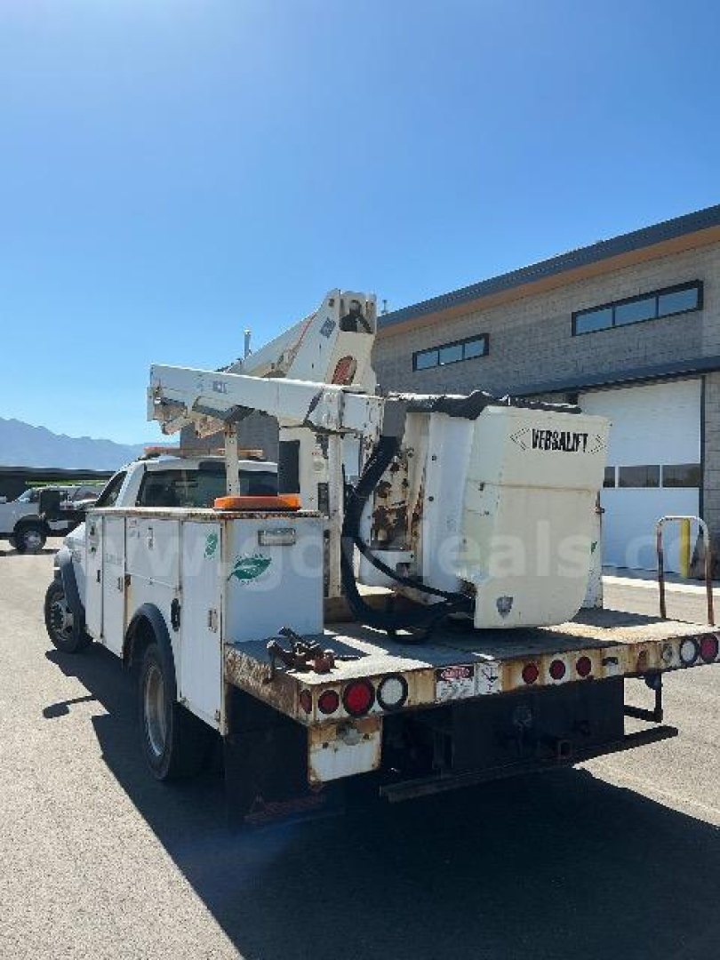 White Dodge Ram 5500 bucket truck rear view with crane and bucket platform, stock number 1428-9277, VIN 3C7WRMBL5EG180645.