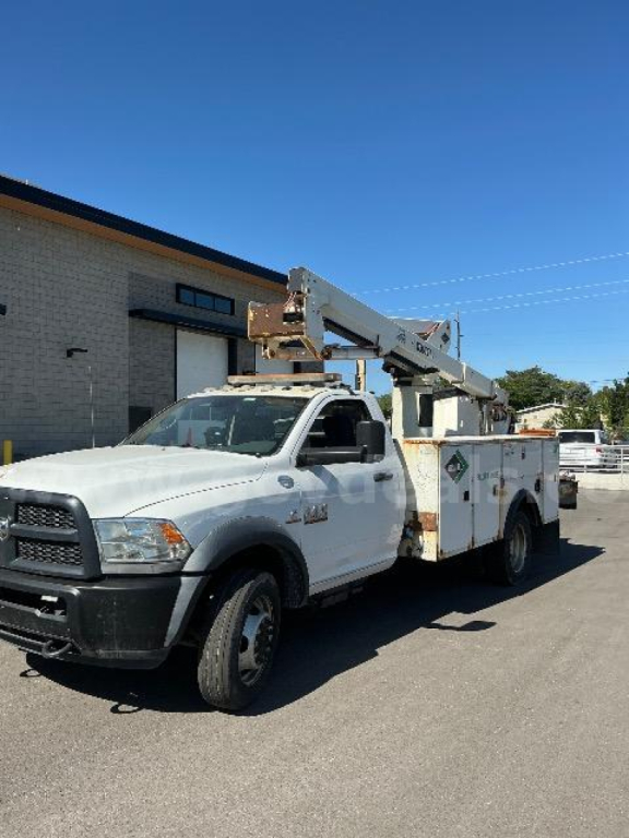 2014 Dodge Ram 5500 bucket truck in service view showing bucket lift mounted on service body.