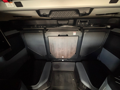 Cab interior of a new 2026 Mack PR64T76H tractor showing dash area and under-dash storage in view.