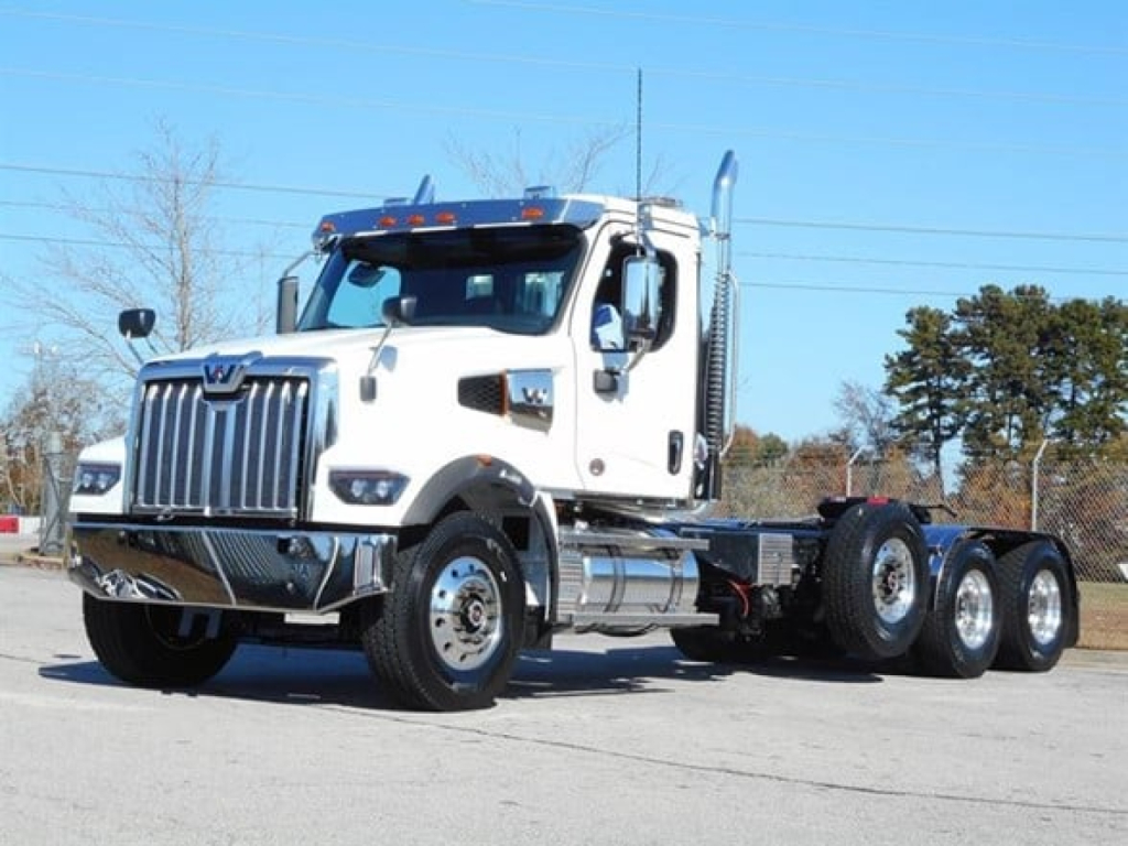 Western Star 49X tractor unit in white, front three-quarter view, with chrome grille and dual rear axles, visible in a parking lot.