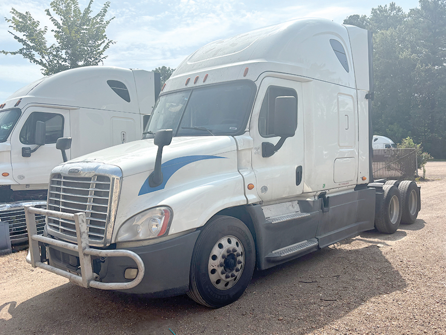 Freightliner Cascadia125 sleeper cab tractor showing front and side, white with blue accents, stock number 557399, VIN partially visible.