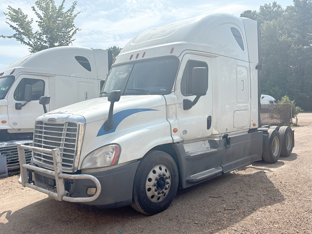 Freightliner Cascadia125 sleeper cab tractor showing front and side, white with blue accents, stock number 557399, VIN partially visible.
