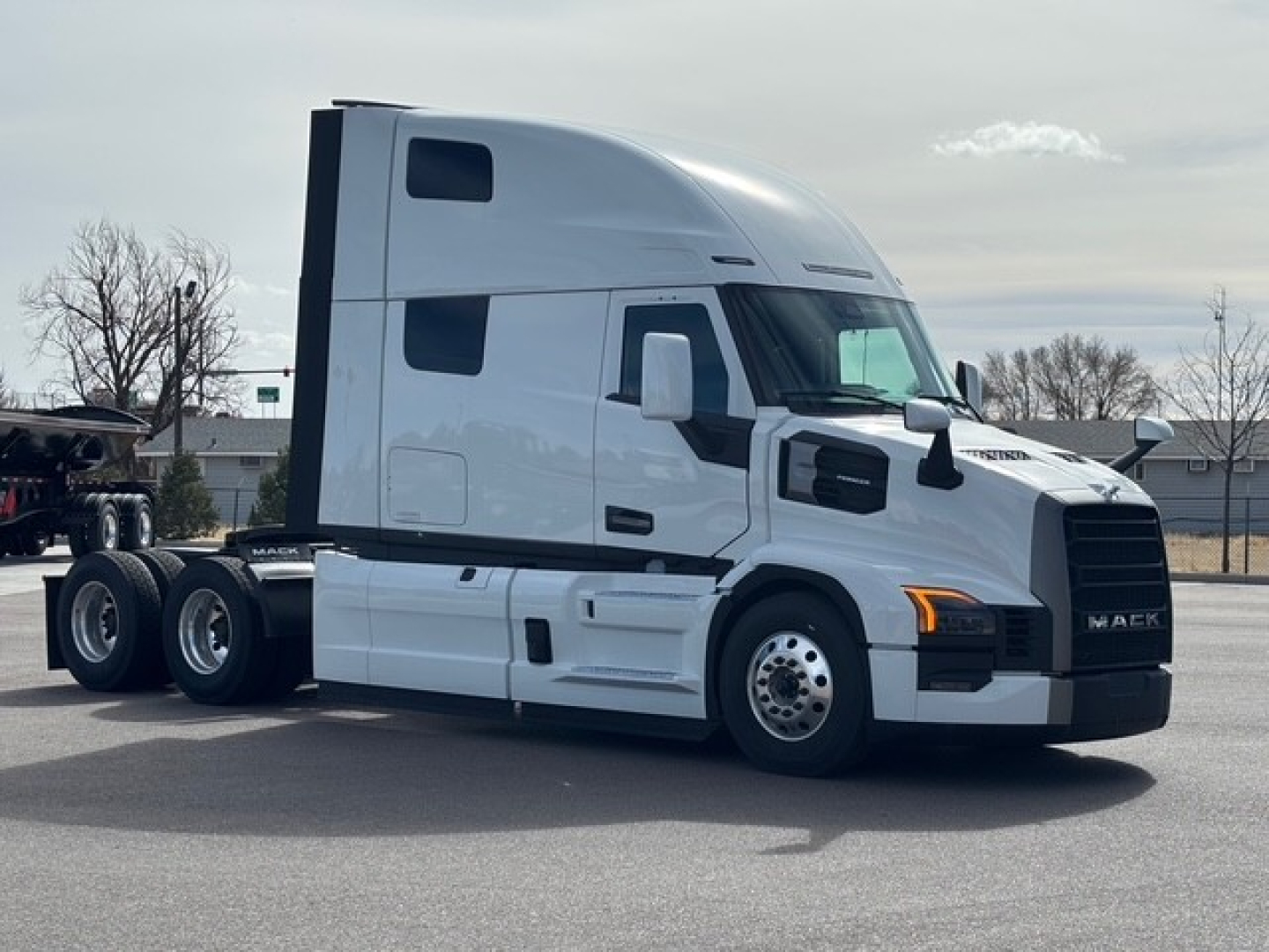 Mack PR64T76H conventional sleeper tractor in profile view showing cab, sleeper, and dual rear axles.